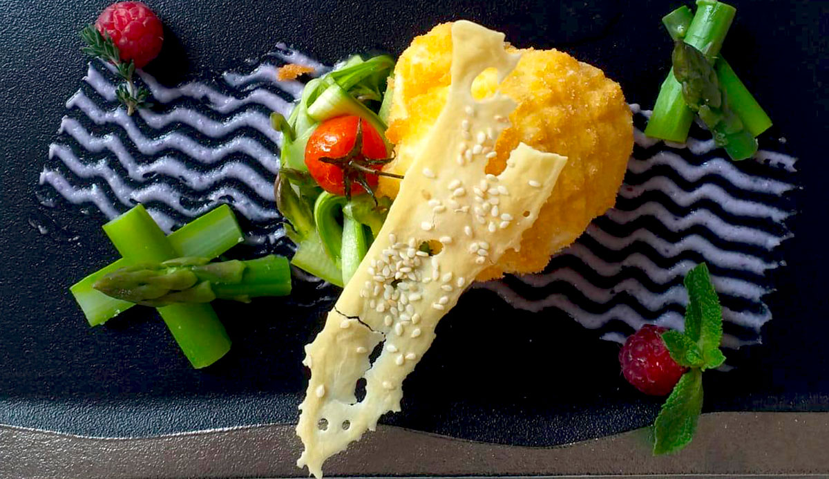 Different types of cheese on a wooden board